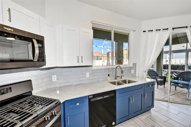 an empty room with wooden floor and bathroom
