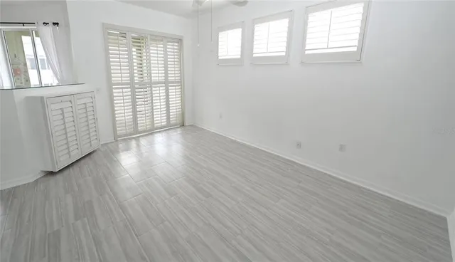 a view of a room with wooden floor and windows