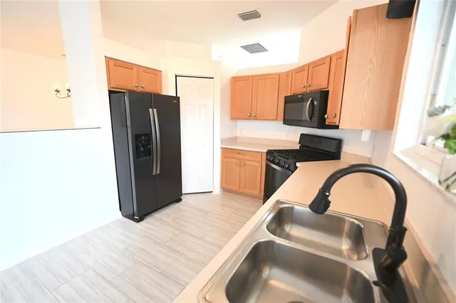 a kitchen with a sink stove and cabinets