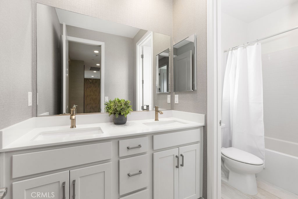 663 Longhorn Way Rancho Mission Viejo, CA 92694 - Photo 22 of 52 a bathroom with a sink a toilet and a mirror