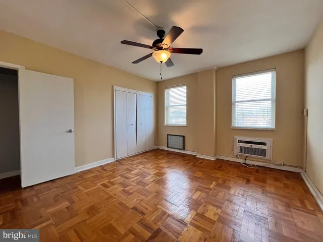 a view of a livingroom with a window and a ceiling fan