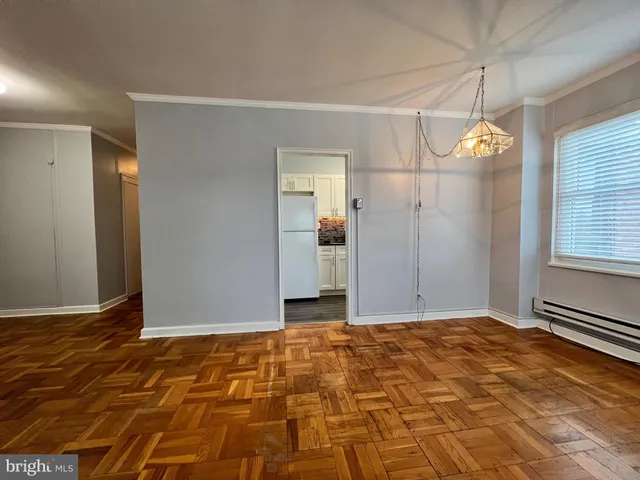 a view of a room with wooden floor closet and windows