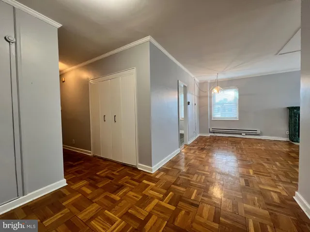 a view of a big room with closet and wooden floor