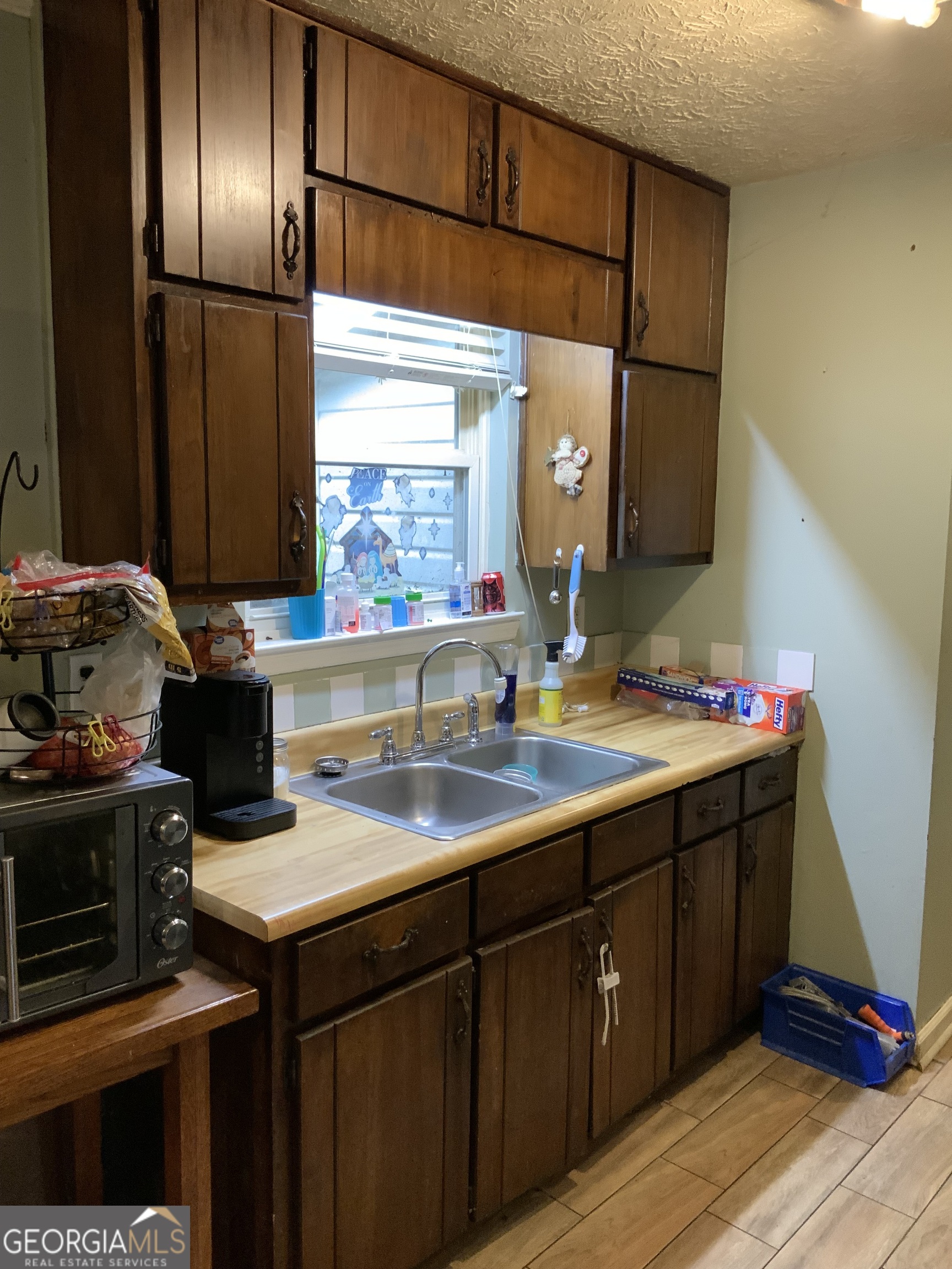 10065 Brass Ring Road Jonesboro, GA 30238 - Photo 23 of 48 a kitchen with a sink and cabinets