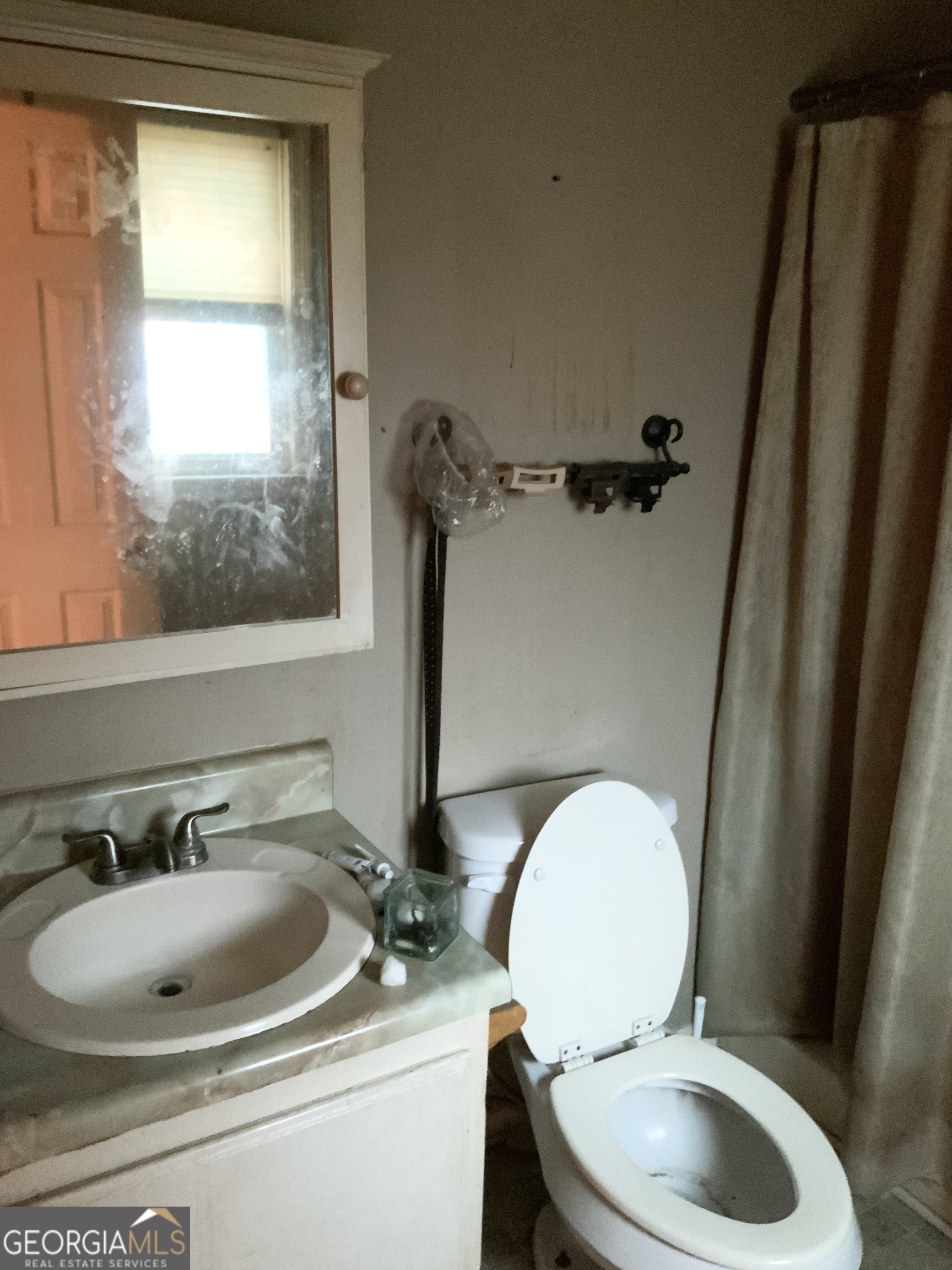 10065 Brass Ring Road Jonesboro, GA 30238 - Photo 32 of 48 a bathroom with a toilet sink and mirror