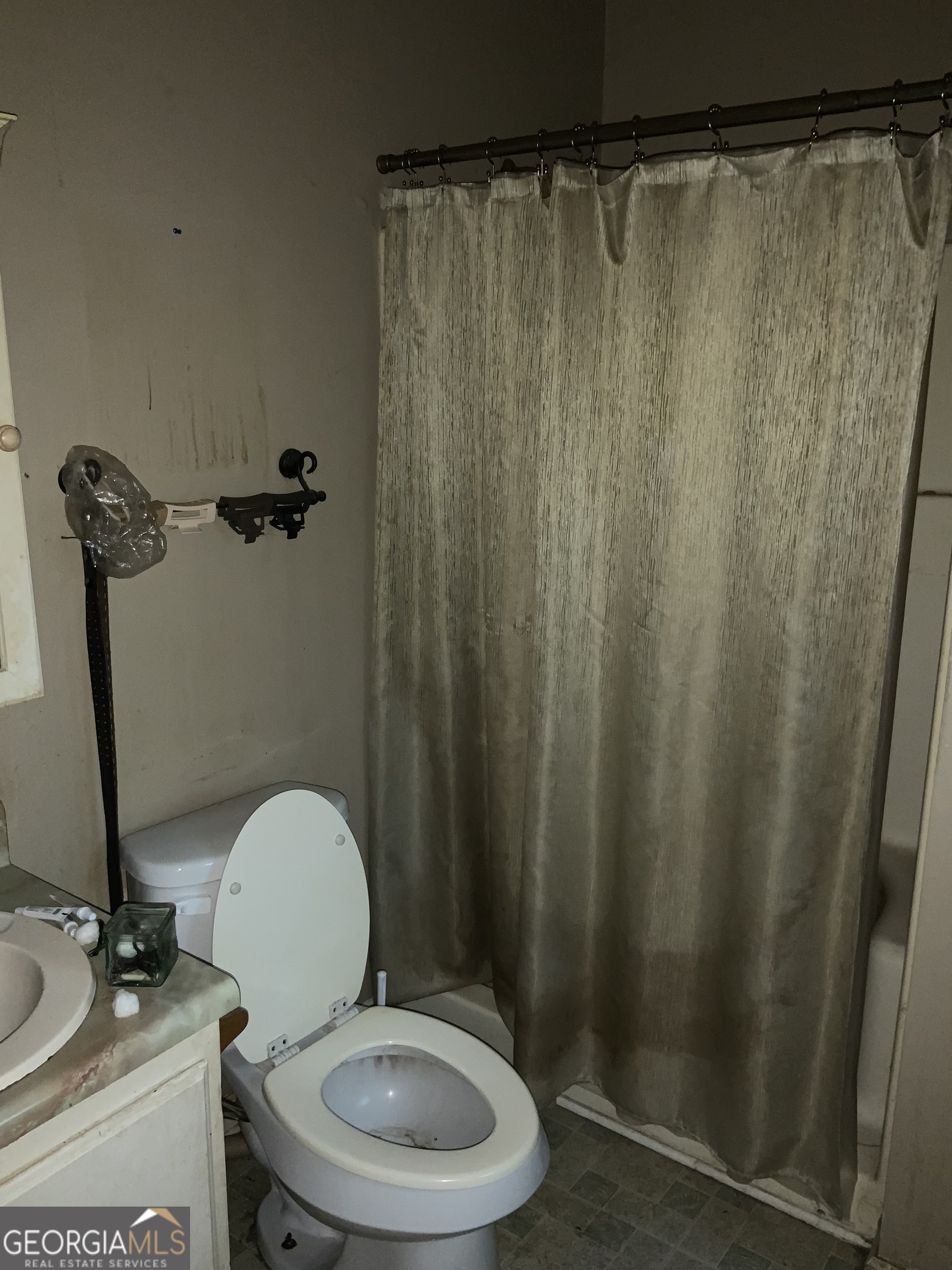 10065 Brass Ring Road Jonesboro, GA 30238 - Photo 34 of 48 a bathroom with a toilet and a shower curtain