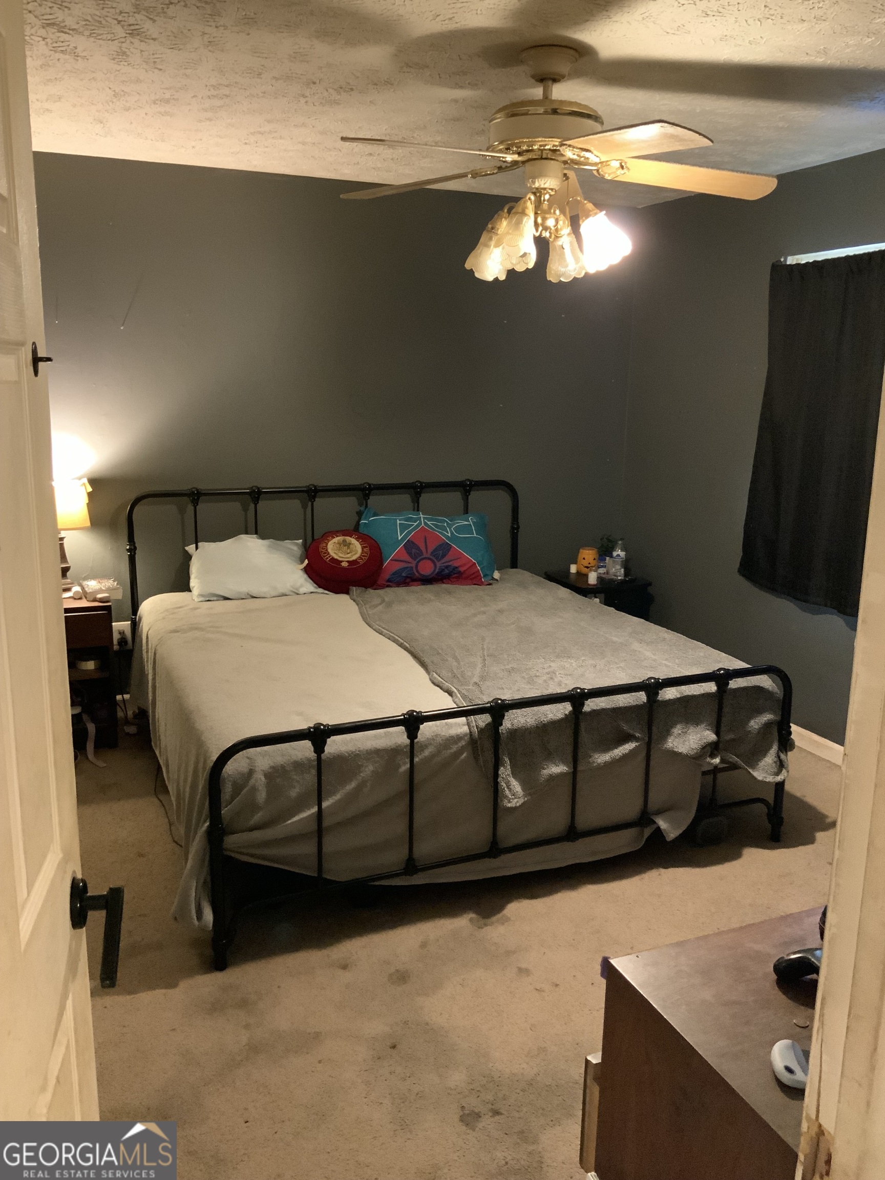 10065 Brass Ring Road Jonesboro, GA 30238 - Photo 9 of 48 a bedroom with a bed and a chandelier