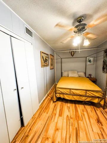 a bedroom with a bed and a mirror