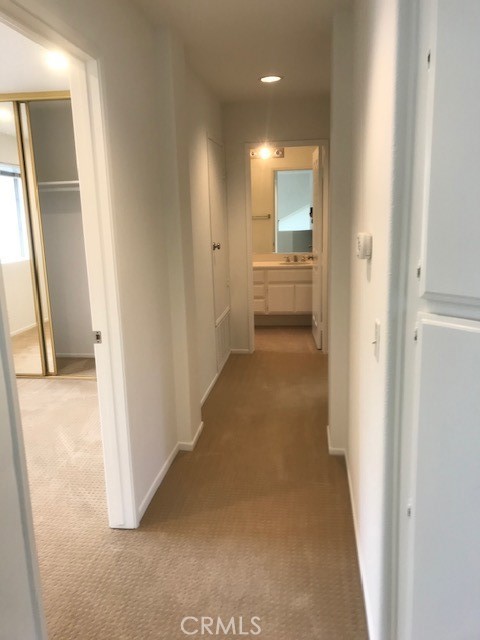 5 Laconia Irvine, CA 92614 - Photo 14 of 35 a view of a hallway with a livingroom and a bathroom with sink