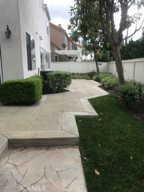 5 Laconia Irvine, CA 92614 - Photo 29 of 35 a view of a white house next to a yard and a large tree