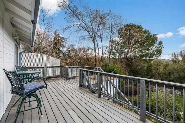 a view of balcony with wooden floor and outdoor seating