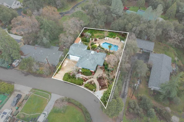 an aerial view of a house with a yard