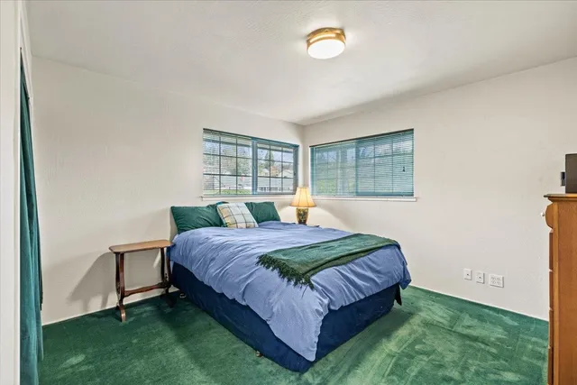 a bedroom with a bed and window