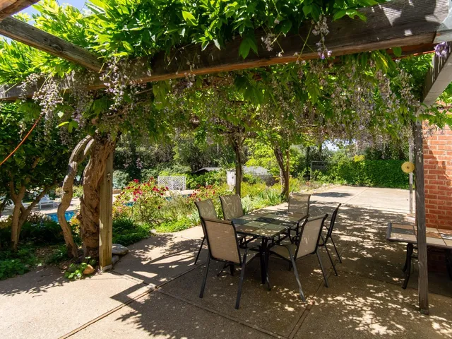 a view of a patio with table and chairs and potted plants