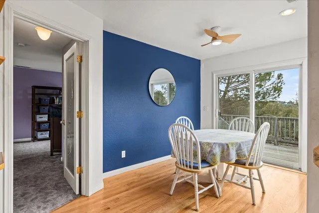 a view of a dining room with furniture a chandelier and wooden floor