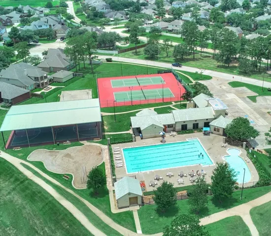 an aerial view of a multi story building with yard