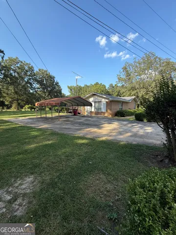 a view of yard with swimming pool and green space