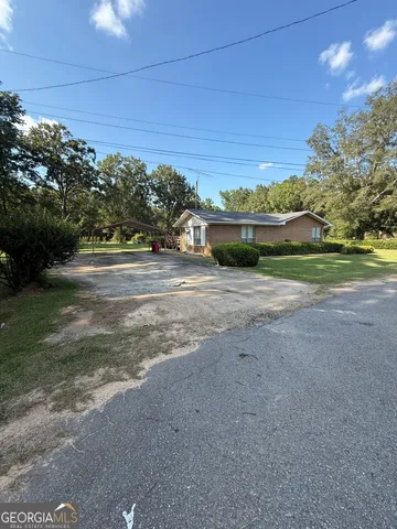 a view of house with staircase and a floor to ceiling window