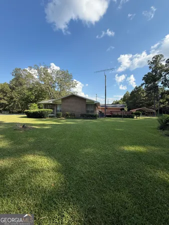 a view of a grassy field with trees