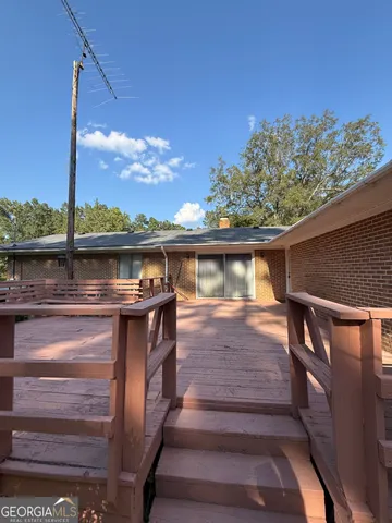 a view of a livingroom with furniture and staircase