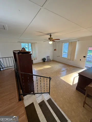 a view of a livingroom with furniture and a flat screen tv