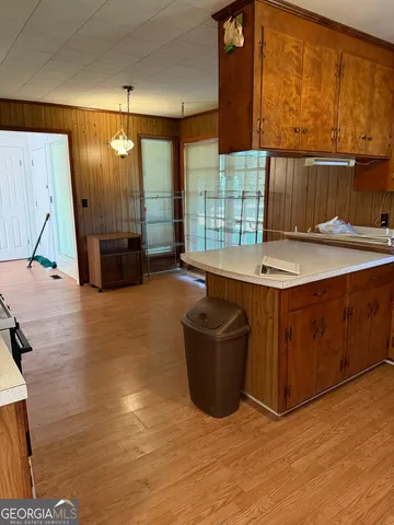 a kitchen with stainless steel appliances wooden cabinets a sink and a stove