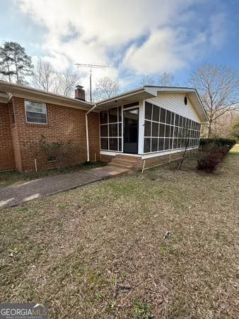 a view of house with staircase and a floor to ceiling window