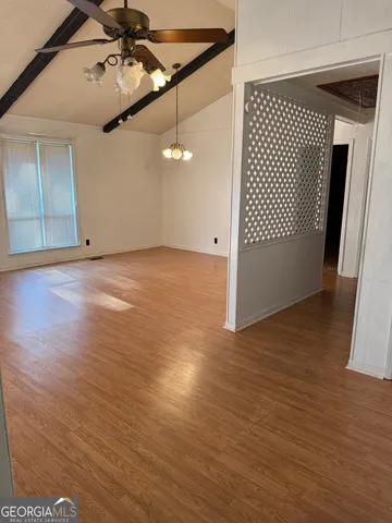 a view of a livingroom with furniture wooden floor and windows
