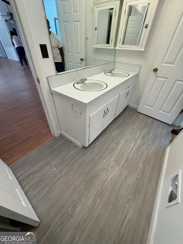 a bathroom with a sink and a mirror