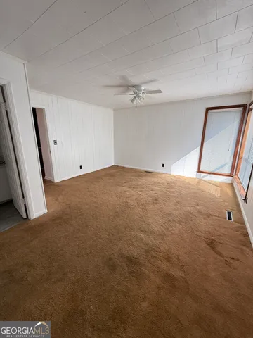 a view of a big room with closet and chandelier fan