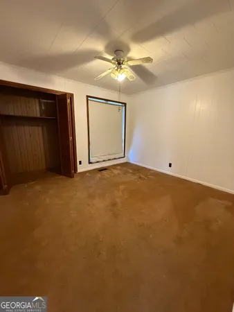 a room with stainless steel appliances wooden floors and kitchen view