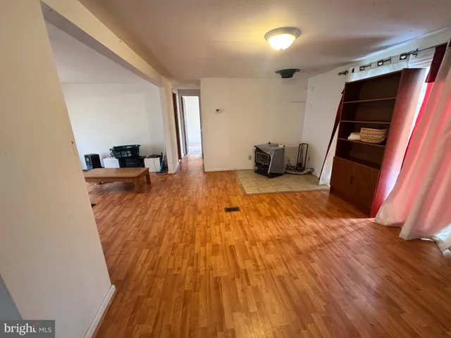 a room with wooden floor and furniture