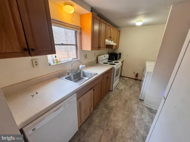 a kitchen with a sink stove and cabinets