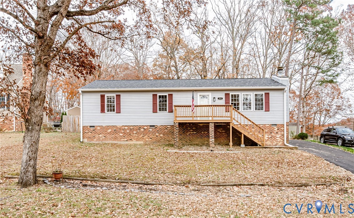 a view of a house with a yard and trees