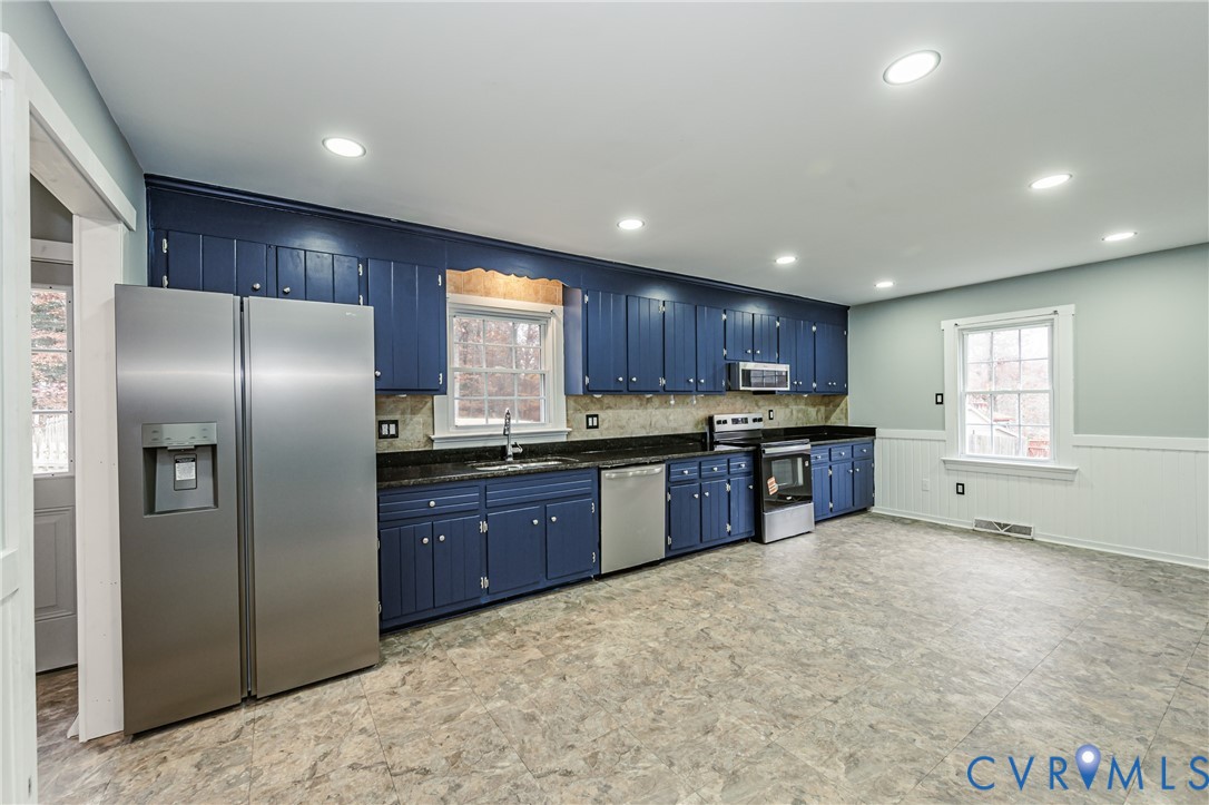 113 Eastman Road Chesterfield, VA 23236 - Photo 14 of 47 a kitchen with stainless steel appliances granite countertop a refrigerator a sink a stove a microwave a counter space and cabinets
