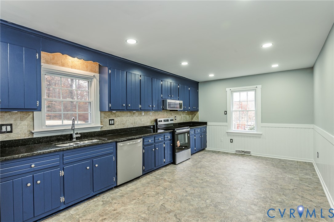 113 Eastman Road Chesterfield, VA 23236 - Photo 15 of 47 a kitchen with granite countertop wooden cabinets a sink and dishwasher
