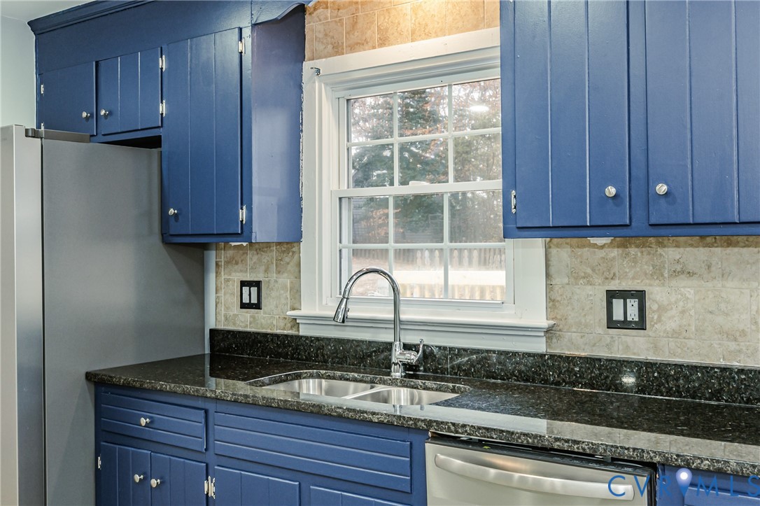 113 Eastman Road Chesterfield, VA 23236 - Photo 16 of 47 a kitchen with granite countertop wooden cabinets a sink and dishwasher
