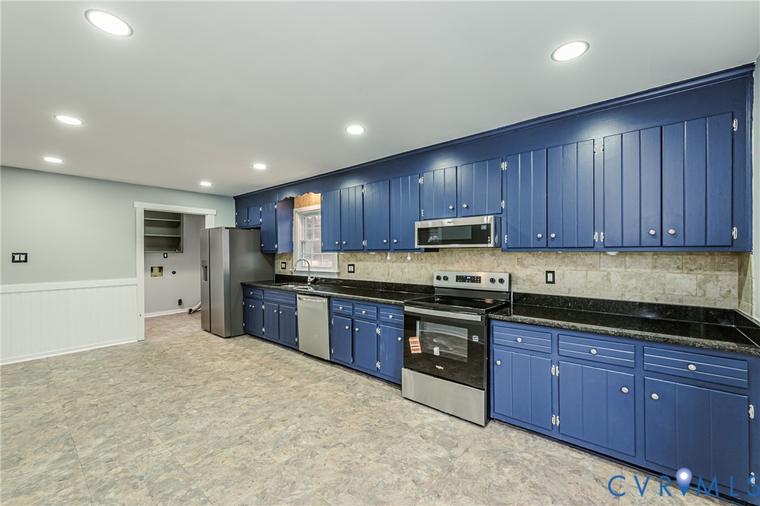 113 Eastman Road Chesterfield, VA 23236 - Photo 19 of 47 a large kitchen with stainless steel appliances granite countertop wooden cabinets a stove top oven a sink and dishwasher