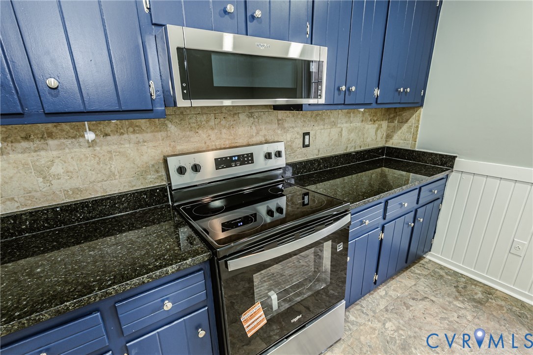 113 Eastman Road Chesterfield, VA 23236 - Photo 21 of 47 a kitchen with wooden cabinets stove top oven and microwave