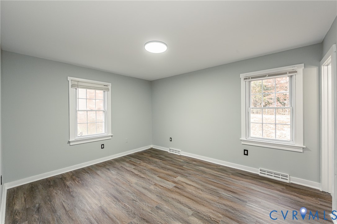 113 Eastman Road Chesterfield, VA 23236 - Photo 33 of 47 an empty room with wooden floor and windows