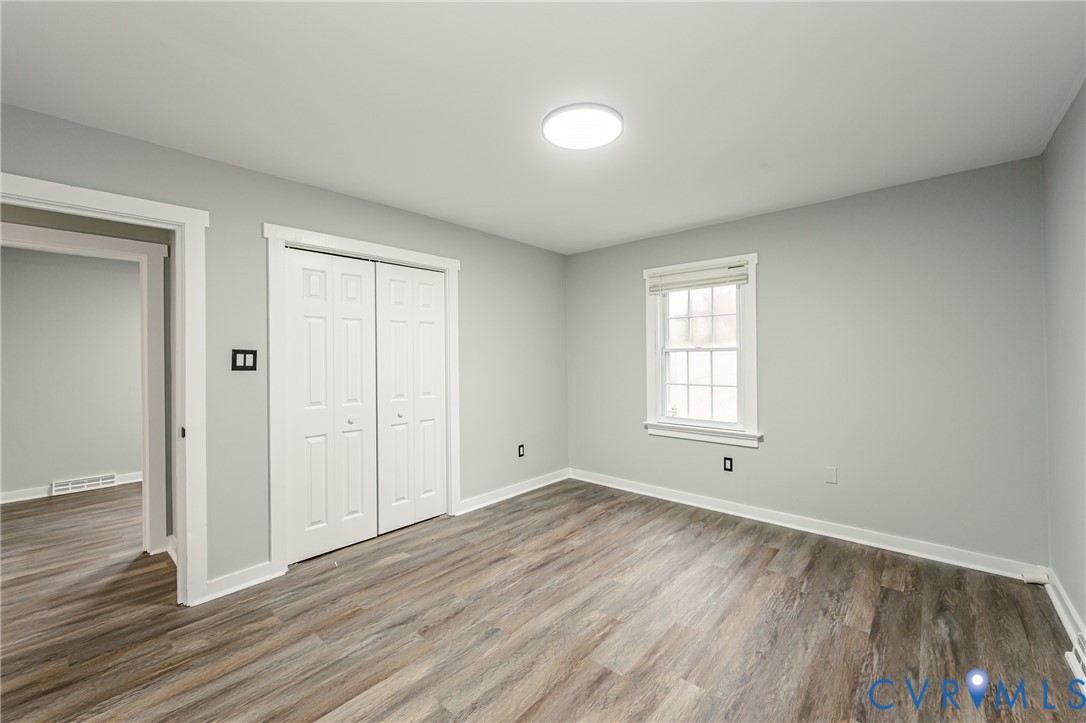 113 Eastman Road Chesterfield, VA 23236 - Photo 36 of 47 a view of an empty room with wooden floor and a window