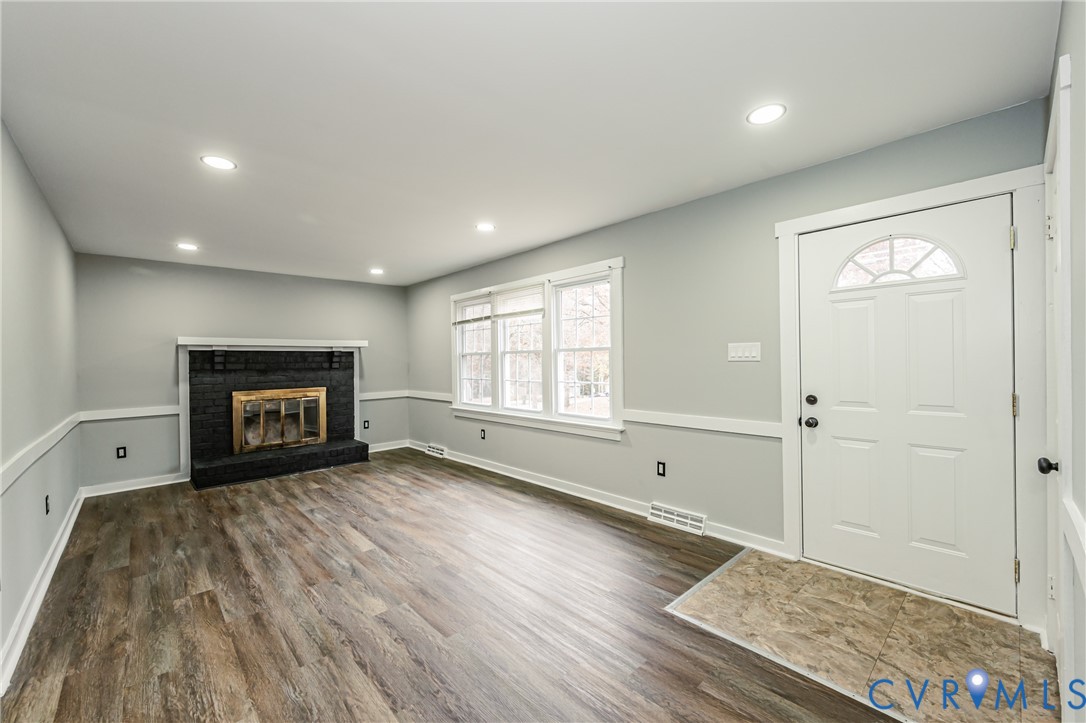 113 Eastman Road Chesterfield, VA 23236 - Photo 8 of 47 a view of empty room with wooden floor and fireplace