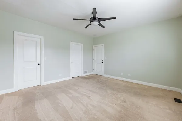 a view of a room with a ceiling fan