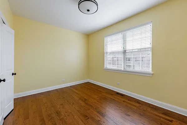 a view of a room with wooden floor and a window