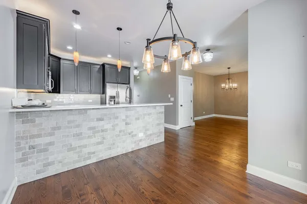 a view of a kitchen with a sink and wooden floor
