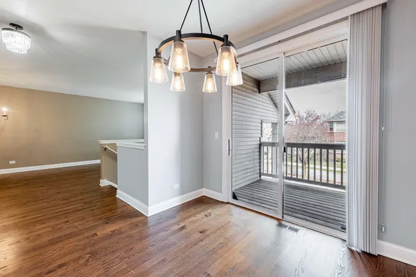 a view of a room with wooden floor and windows