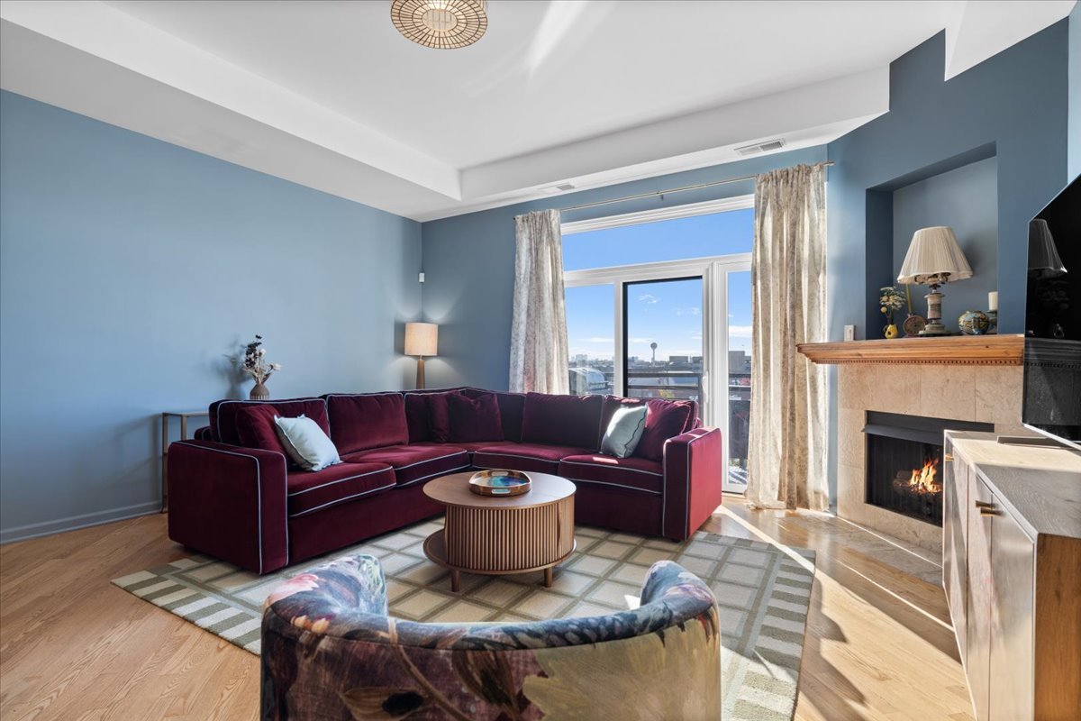 2337 West Wolfram Street, Unit 514 Chicago, IL 60618 - Photo 6 of 15 a living room with furniture a fireplace and a flat screen tv