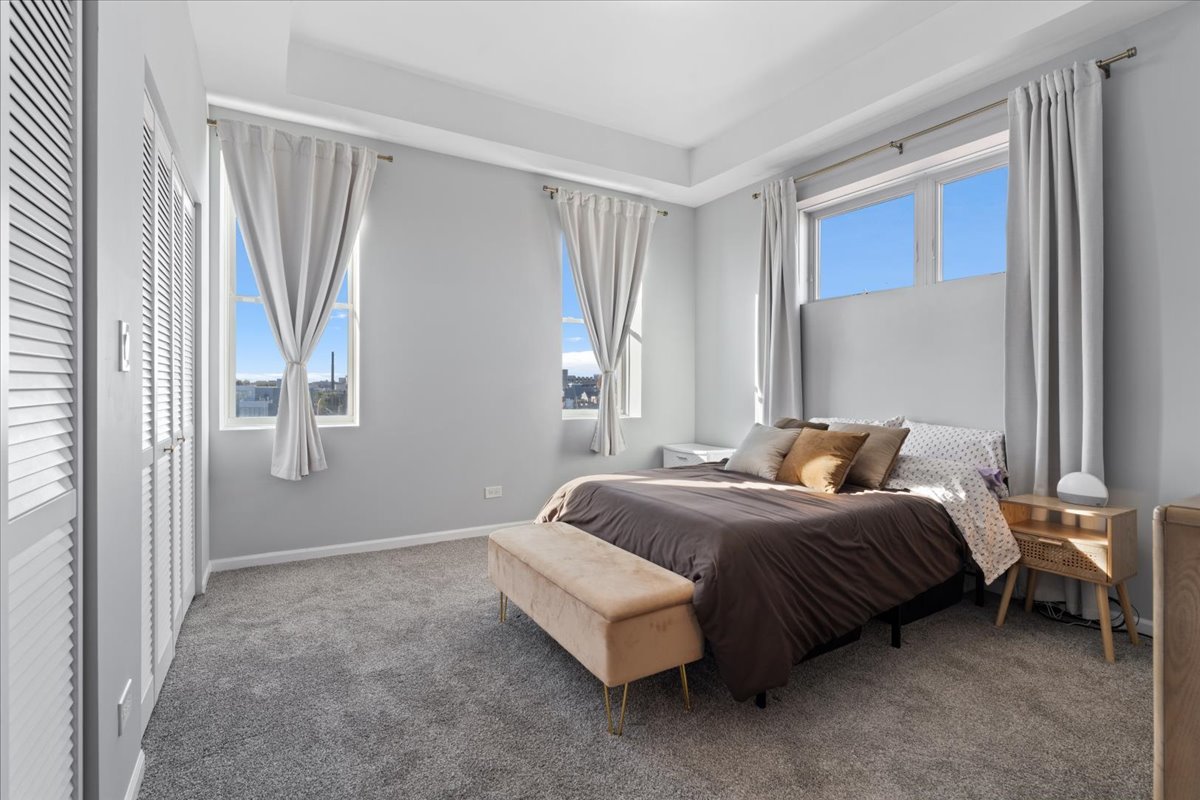 2337 West Wolfram Street, Unit 514 Chicago, IL 60618 - Photo 8 of 15 a spacious bedroom with a bed and a window