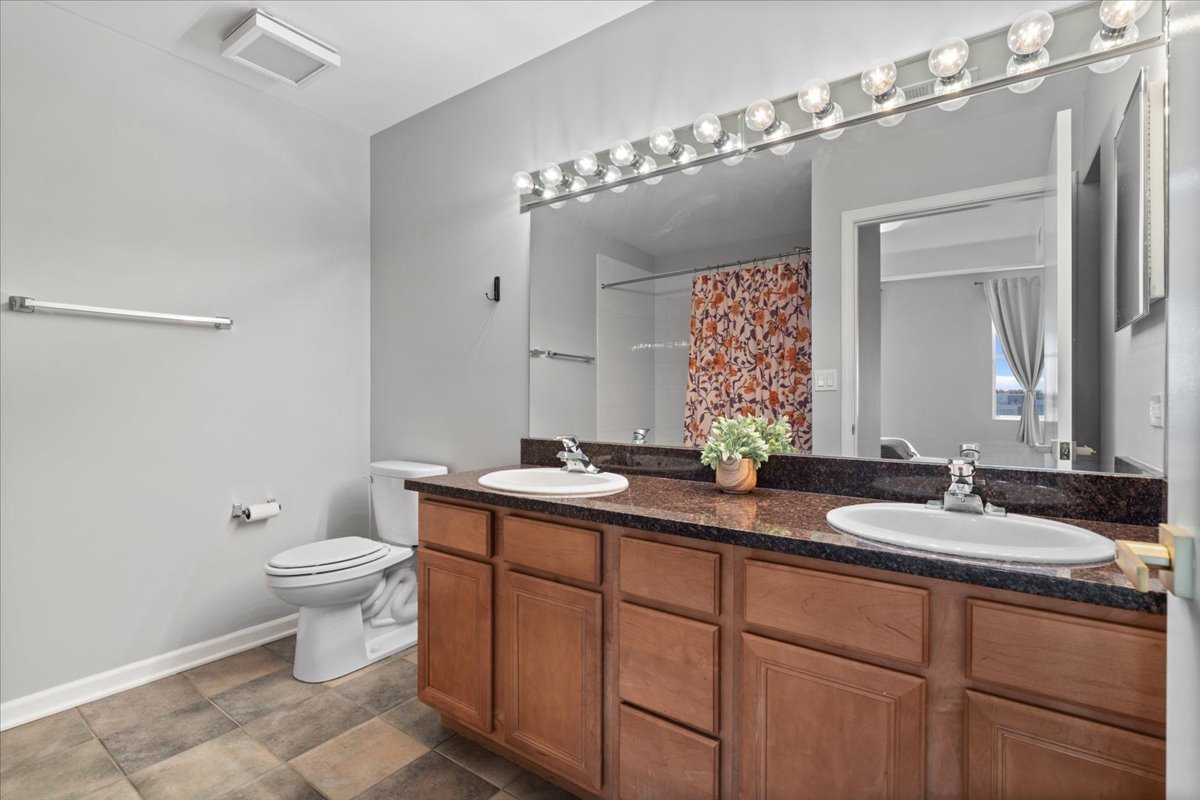 2337 West Wolfram Street, Unit 514 Chicago, IL 60618 - Photo 10 of 15 a bathroom with a double vanity sink and a mirror