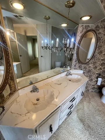 a bathroom with a double vanity sink and a mirror